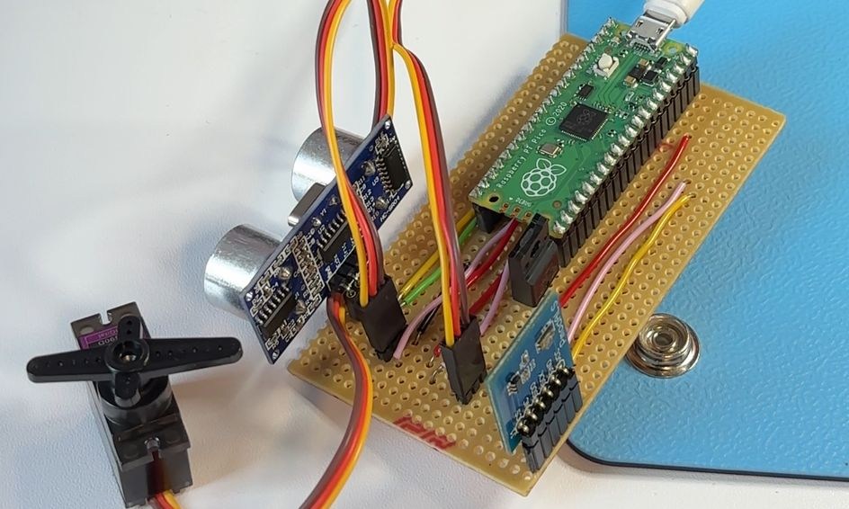 Hand soldered robot control board on Veroboard with Raspberry Pi Pico, ultrasonic sensor and servo